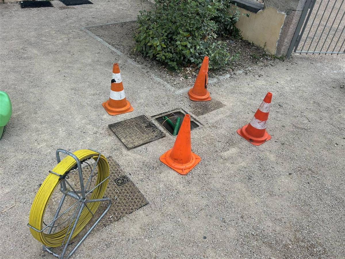 Le même regard télécom ouvert après localisation à la sonde, fourreau et gaine visibles au fond de la chambre